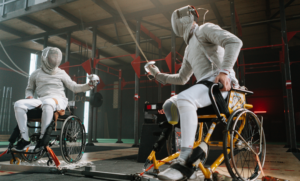 Competitive wheelchair fencing match showcasing athletes in action