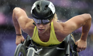 Para cycling athletes conquering steep climbs using adaptive equipment.