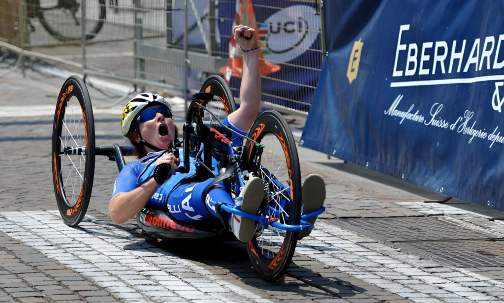 Para cycling athletes conquering steep climbs using adaptive equipment.